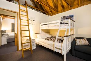 a bedroom with bunk beds and a ladder at Kummonin in Dinner Plain