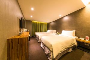 Postel nebo postele na pokoji v ubytování Goodmore Hotel