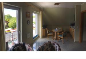 a kitchen and dining room with a table and chairs at Ferienwohnung Altenkirchen 1 in Altenkirchen