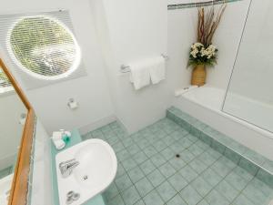 
a bathroom with a sink, toilet and tub at Compass Point in Hamilton Island
