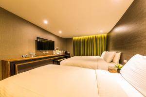 Postel nebo postele na pokoji v ubytování Goodmore Hotel