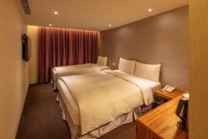 Postel nebo postele na pokoji v ubytování Goodmore Hotel