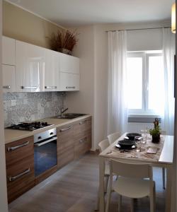 una cucina con tavolo e sedie e una sala da pranzo di Blue Nest Apartment a Torbole