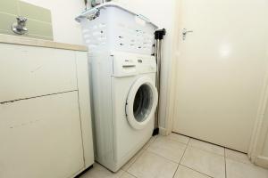 a white washer and dryer in a small room at Downstairs in Hawthorn in Melbourne