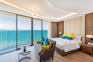 a bedroom with a bed and a couch and windows at Panorama Nha Trang Star Beach in Nha Trang +63 photos