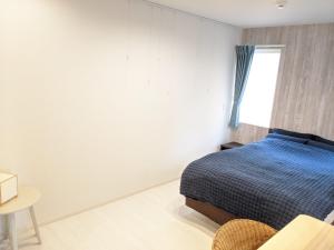 Postel nebo postele na pokoji v ubytování Port House Shibuya