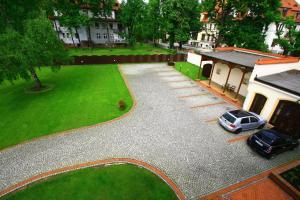 a car parked in a driveway next to a house at Hotel Pałacyk in Legnica