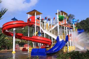 a water slide at a water park with people on it at Bukit Merah Laketown Resort in Taiping