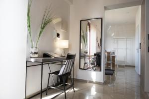 a room with a table and chairs and a mirror at New Gate City Break Suite in Heraklio