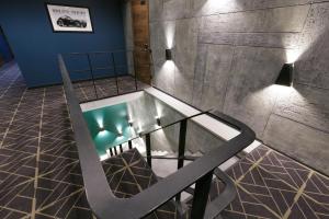 a bath tub in a room with a staircase at Kulikovskiy hotel in Kharkiv