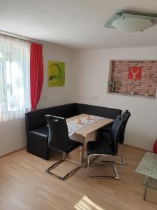 a dining room with a table and black chairs at Ferienwohnung Bleimuth in Passail +23 photos