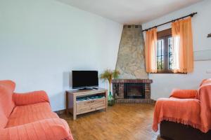 a living room with a tv and a fireplace at Casas Rurales El Mirador F in Vejer de la Frontera
