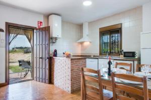 a kitchen with a table and a dining room at Casas Rurales El Mirador F in Vejer de la Frontera