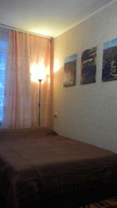 ニジニ・ノヴゴロドにあるApartment on Zvezdinkaのベッドルーム1室(ベッド1台、ランプ、窓付)