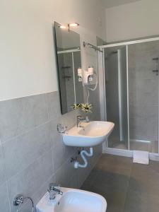 uma casa de banho com um lavatório e um chuveiro em HOTEL LORENA em Toscolano Maderno