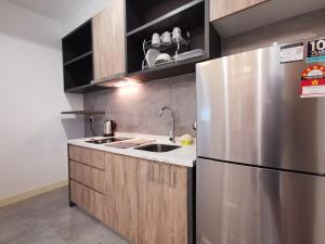 a kitchen with a stainless steel refrigerator and a sink at Thermospace Imperio B-25-31 Melaka City in Melaka