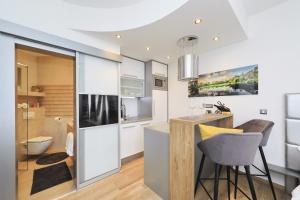 a kitchen with white cabinets and a counter with a sink at Villa Dalmatino in Pakoštane