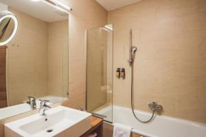 a bathroom with a sink and a shower at Heritage Hotel Hallstatt in Hallstatt