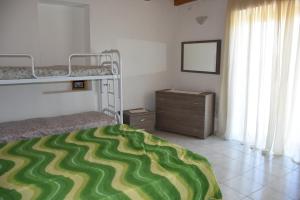 a bedroom with two bunk beds and a dresser at Su Cuile relax house with barbecue in Martis