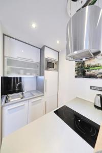 a kitchen with white cabinets and a counter top at Villa Dalmatino in Pakoštane