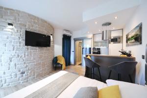 a hotel room with a stone wall and a bar at Villa Dalmatino in Pakoštane
