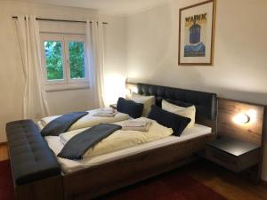 a large bed in a room with a window at Alpenlodge in Garmisch-Partenkirchen
