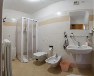 a bathroom with a sink and a toilet and a shower at Agriturismo Cascina Cornella in Cremeno