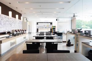 a large kitchen with a table and chairs at Lynn Hotel Serang in Serang