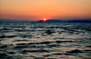 a sunset over a large body of water at Hotel Puccinelli in Lido di Camaiore