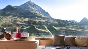 a living room with a view of a mountain at Hotel Jagdschloss Resort in Kühtai