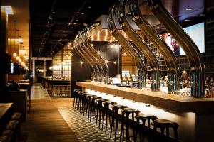 a bar with a row of stools in a restaurant at JEN Beijing by Shangri-La in Beijing