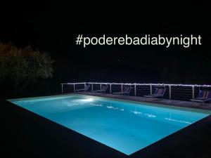 a swimming pool at night with lights around it at Podere Badia Valdrago Agriturismo Mugello Circuit in Scarperia