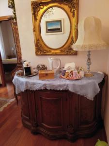 a dressing table with a mirror and a lamp at Stella di mare in Cagliari