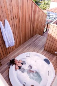 a woman laying in a bath tub on a deck at Hotel Pop Alaçatı in Alacati