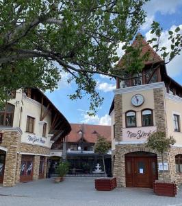 a building with a clock on top of it at New York Pension in Dunajská Streda