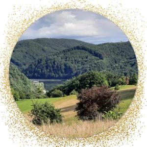 a round mirror with a view of a mountain at Holiday Home Neokrnjena Narava in Sevnica