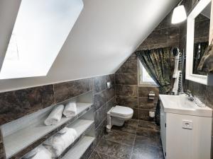 a bathroom with a sink and a toilet at Platan Udvarhaz in Tata