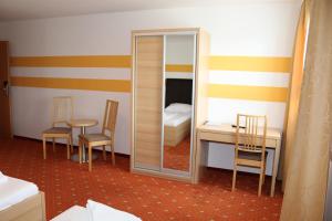 a room with a mirror and a table and a bed at Lenas Donau Hotel in Vienna