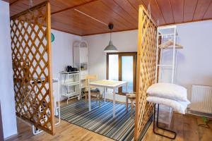 a room with a desk and a table with a chair at Charlietown in Satu Mare