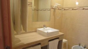 a bathroom with a sink and a mirror at Apartamentos Cabrita in Albufeira