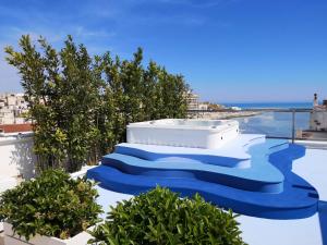 a set of blue stairs with a hot tub on top at Relais La Pretura in Vieste