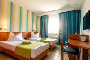 Postel nebo postele na pokoji v ubytování Hotel Apollo