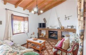 a living room with a couch and a fireplace at Casa Lola in Sayalonga