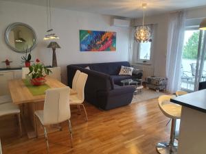 a living room with a blue couch and a table at Apartment Rose in Zagreb