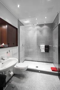 a bathroom with a shower and a toilet and a sink at Business Suiten in Bochum