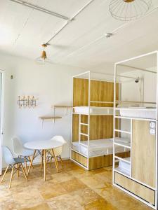 a room with a table and a bunk bed at Inhawi Boutique Hostel in St. Julianʼs