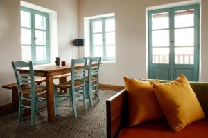 a living room with a table and chairs and a couch at Rizes in Psárion