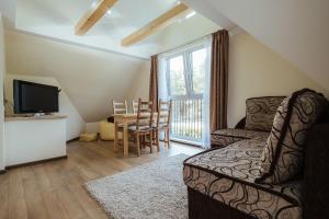 a living room with a couch and a table at Pas Aldona in Palanga