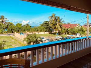a balcony with a view of a parking lot at Erica's Self Catering Apartment in Mahe
