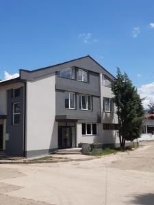 a black and white building on a street at Vila Oska in Vinica